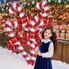Christmas bows, candy canes, aluminum foil balloons with red and white stripes for a happy Christmas and New Year outfit