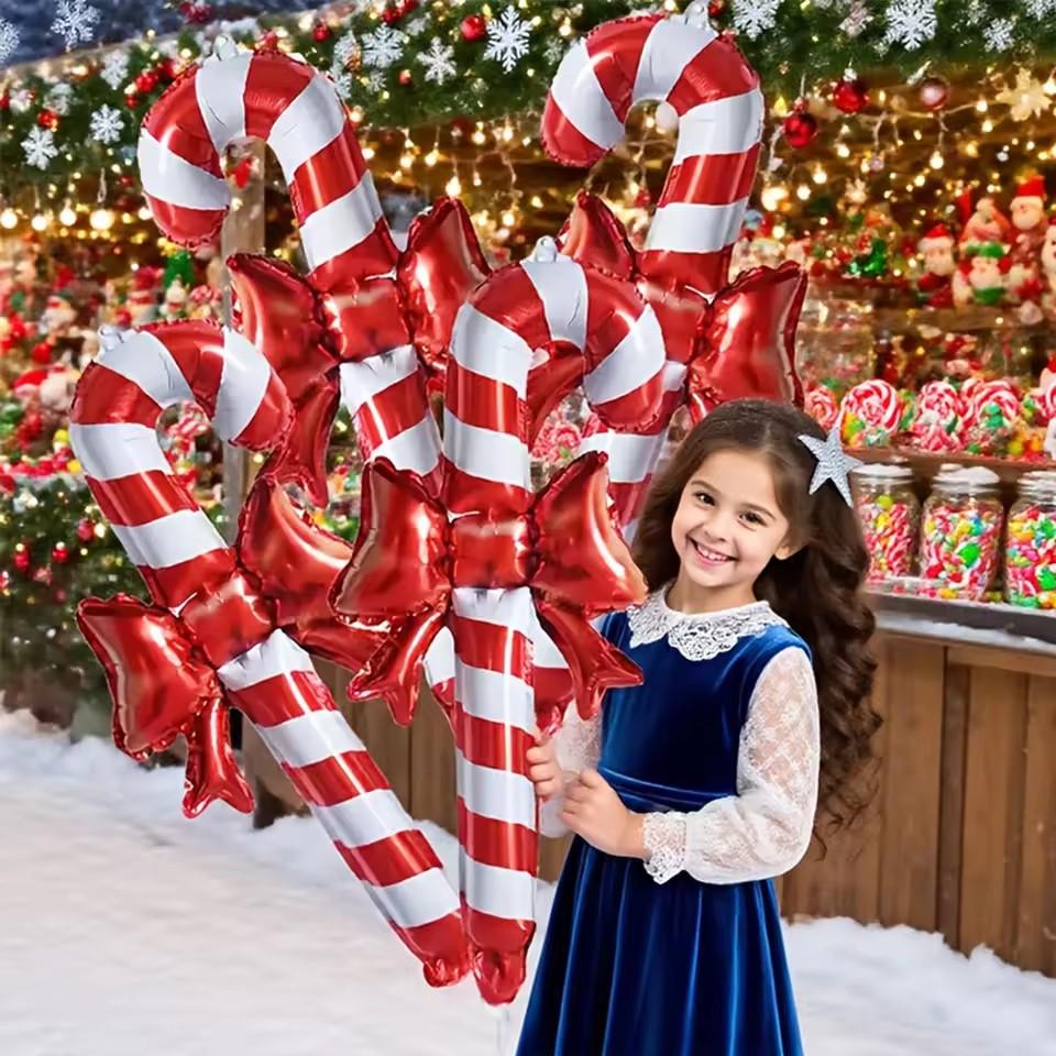 Christmas bows, candy canes, aluminum foil balloons with red and white stripes for a happy Christmas and New Year outfit