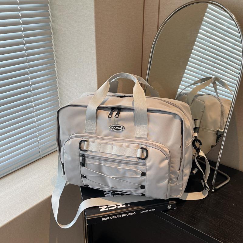 

Large capacity leisure sports fitness bag new versatile business trip short trip bag hand luggage bag серый