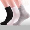 100 Pairs of Medium-Tube Black and White Disposable Socks for Men and Women, Durable and Wash-Free - Ideal for Foot Bath Shops.