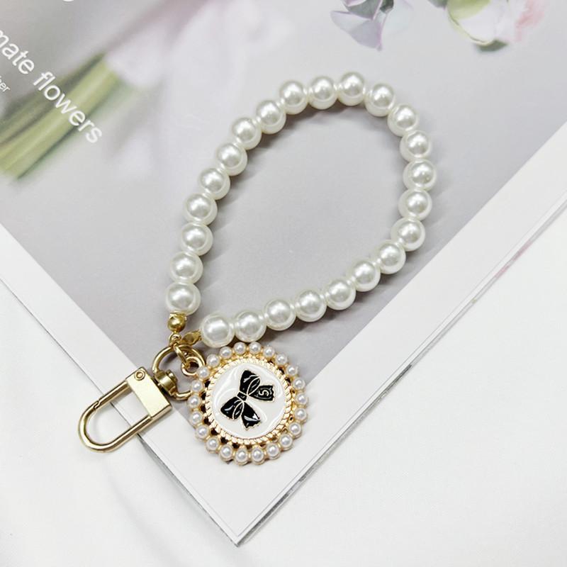 

Short Plastic Pearl Bead Phone Chain Bow Circular Pendant Phone Hanging Chain Wrist Chain Phone Case Accessory Simple and Cute