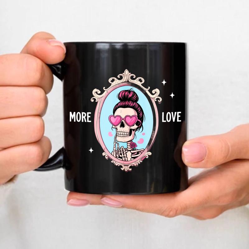 Black ceramic mug with skull and heart-shaped glasses design with More Love printed on it, perfect for coffee, tea or as a gif чёрный