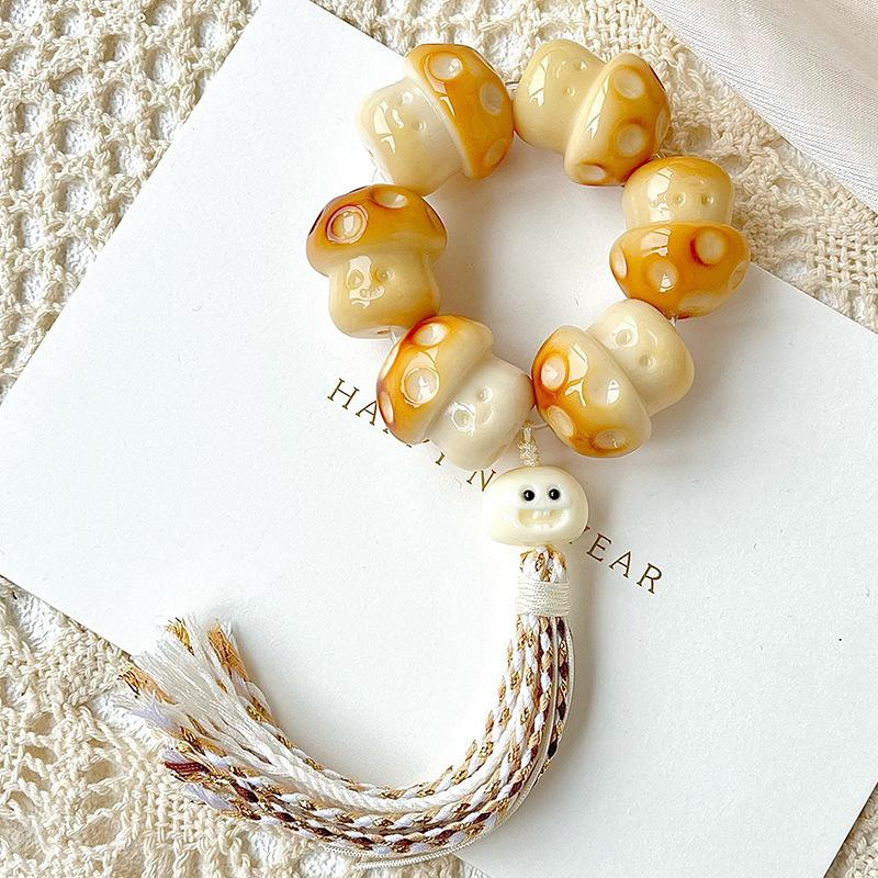 

Natural ivory fruit carving charcoal-burned smiling face mushroom hand toy, fingertip toy, hand-twisted cultural toy, Buddhist bead bracelet 【Jiuwei22-25mm】Hand-t