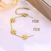 Elegant Gold-Plated Stainless Steel Daisy Jewelry Set: Necklace, Bracelet, and Earrings.