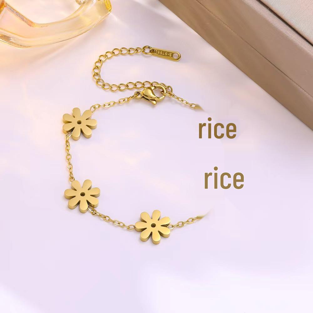 Elegant Gold-Plated Stainless Steel Daisy Jewelry Set: Necklace, Bracelet, and Earrings.