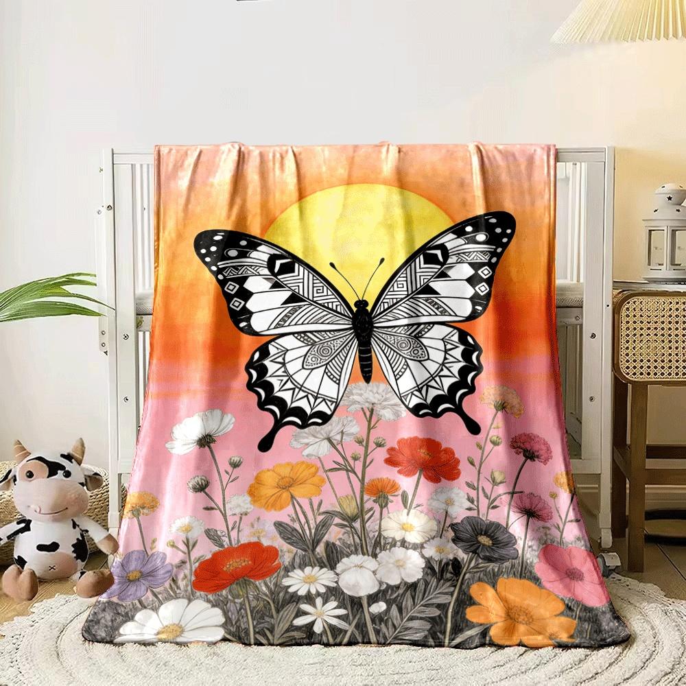 A black-and-white patterned butterfly over colorful flowers and a sunset. for all seasons blanket lunch break throw gift 80cm x 120cm
