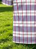 Men's Short-sleeve Polo Shirt, Available in Multiple Sizes. Features a Button- Collar with a Red and Blue Checkered Stripe Pattern on a White Base.