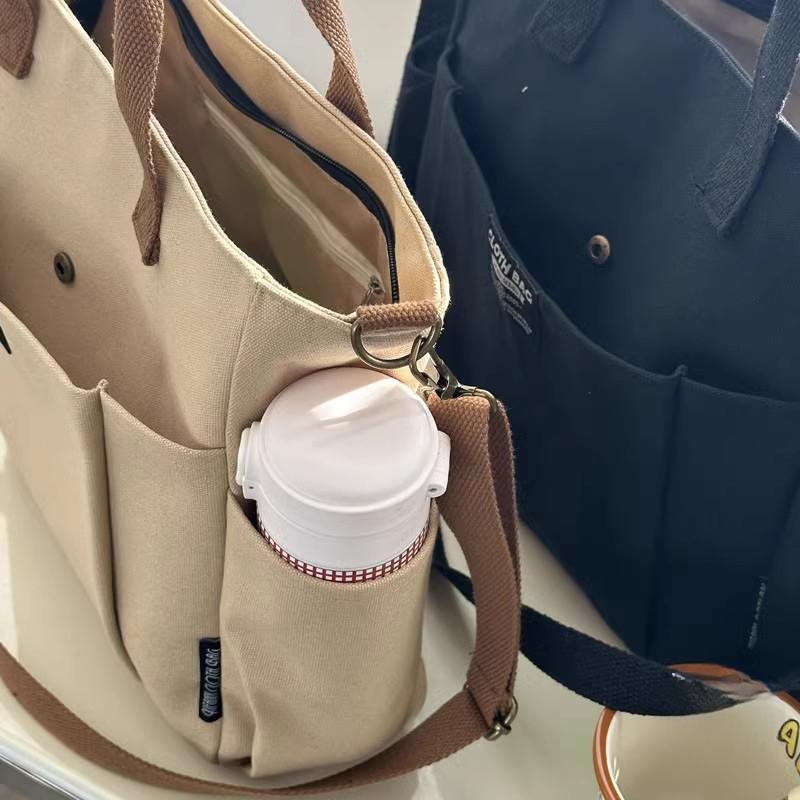 Borsa tote portatile per studentesse urbane minimaliste, grande capacità, pendolarismo, tela orizzontale, spalla singola, croce diagonale