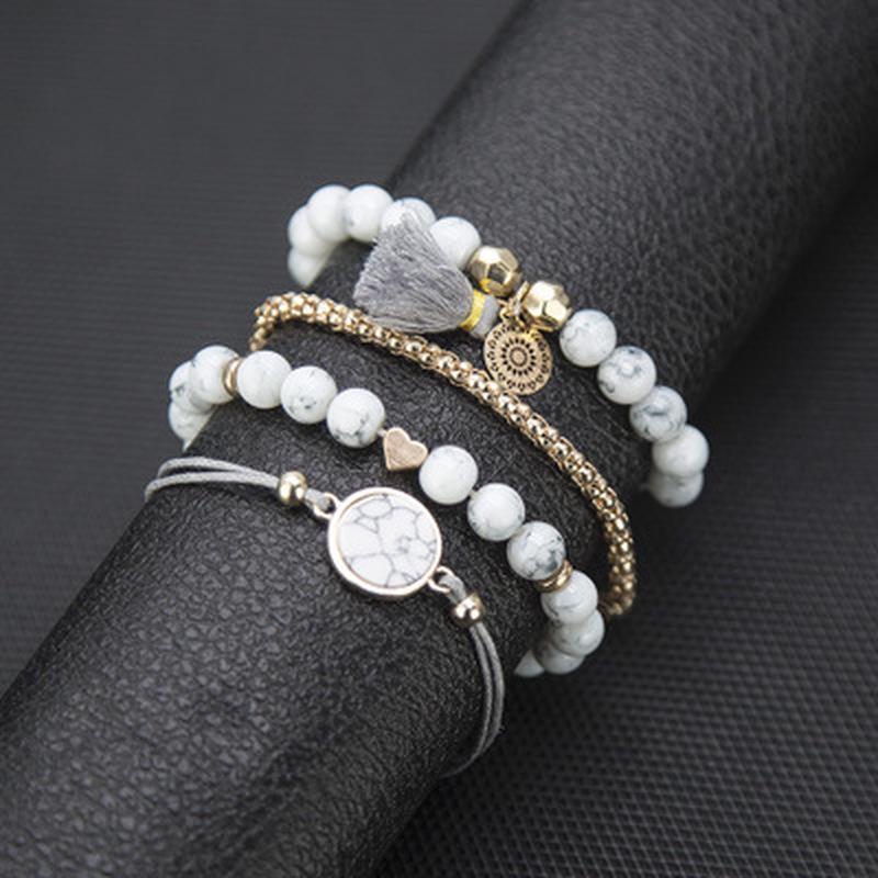 

Геометрически полые металлические цветы, кисточки, бирюзовые шары, любовные браслеты, наборы из четырех предметов. золотой