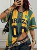 Maglietta Y2K Stile Brasile Strisce Verdi e Gialle Vestibilità Larga Scollo a V Streetwear Stile Donna Sportiva Elegante T-Shirt