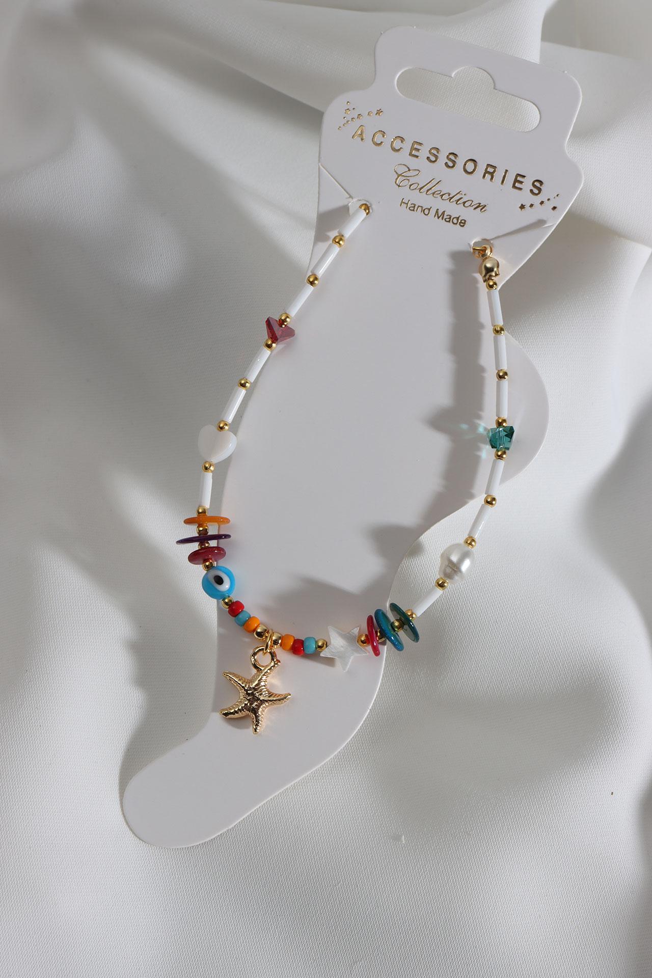 

Браслет с отделкой в ​​виде морской звезды белого цвета и бисером золотого цвета