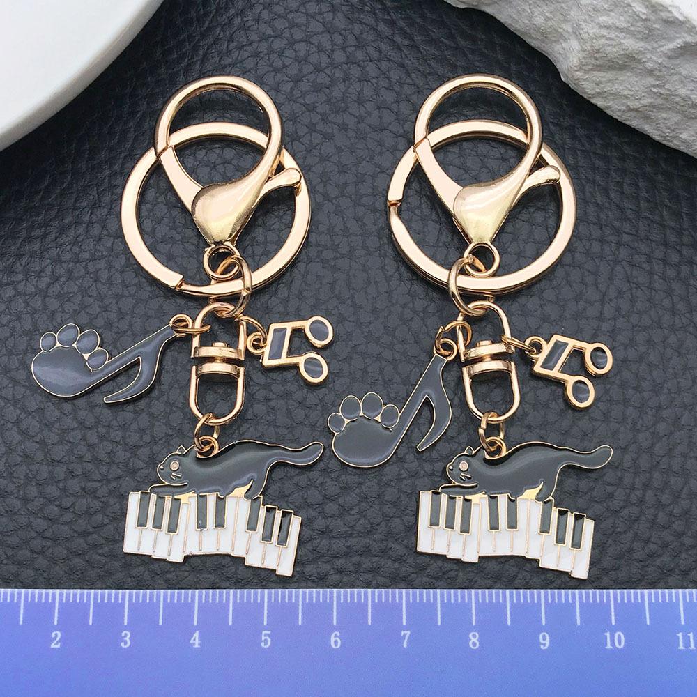 Well-Behaved Black Cat Zinc Alloy Keychain: Cute Drip Oil Cartoon Pendant for Backpacks