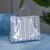 Neue Handheld-Geschenkverpackungstasche Wasserdichte Handtasche mit großem Fassungsvermögen PVC-Laser-Tote Bekleidungsgeschäft