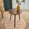A Simple, Casual and Artistic Small Round Table Beside the Balcony Sofa, a Small Round Table and a Small Coffee Table