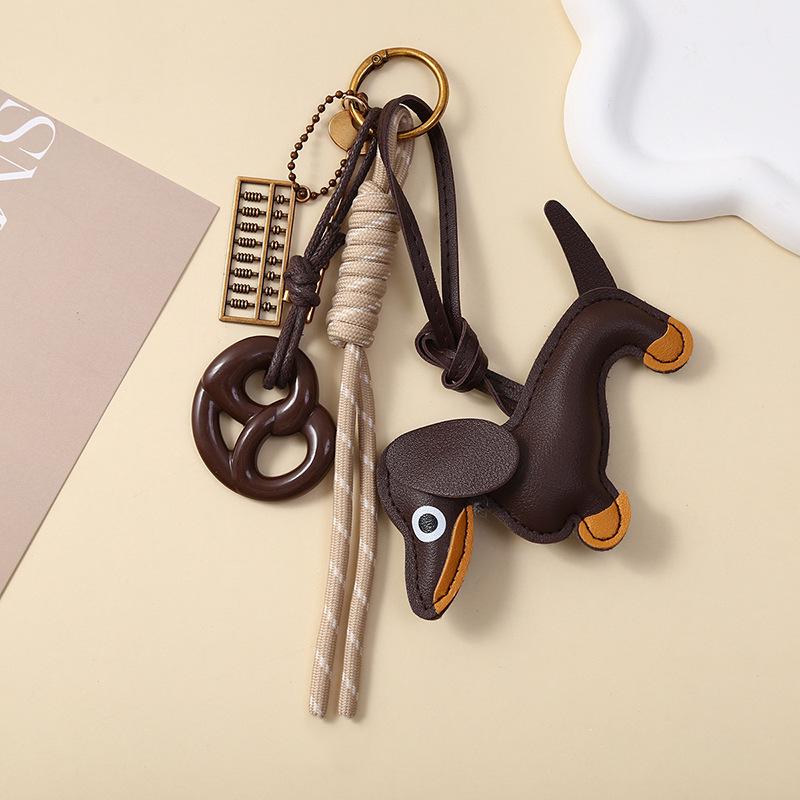 

International Handcrafted Leather Bags, Ornaments, Keychains, Pretzel & Kitten Pendants, Accessories, and Cute Bag Charms.