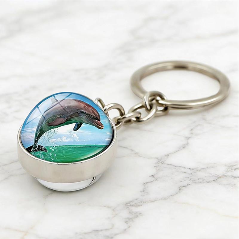 Doppelseitiger Schlüsselanhänger mit Glaskugel und Meeresleben: Delfin, Schildkröte, Seestern