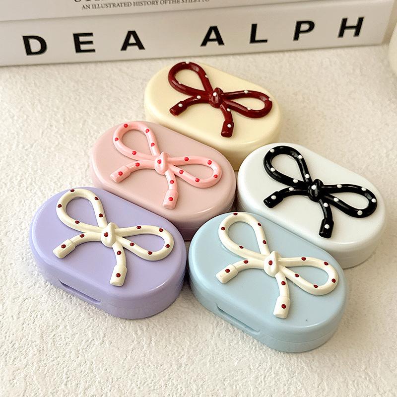 Bonbonfarbene Kontaktlinsenbox Niedliche Schleife Kontaktlinsenbehälter mit Pinzette Entfernerwerkzeug Stift-Set für Reise-Set Halter