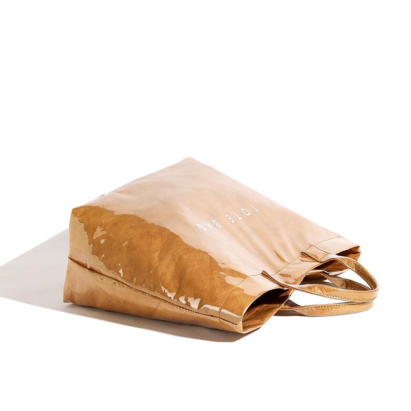 Glänzende DuPont-Papier- und PVC-Tragetasche mit kräftiger Beschriftung und wasserabweisendem Design