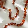 Stylish Red Resin Irregular Bead Necklace With Adjustable Length For Personalized Fit And Artistic Design In Sturdy Alloy Construction.