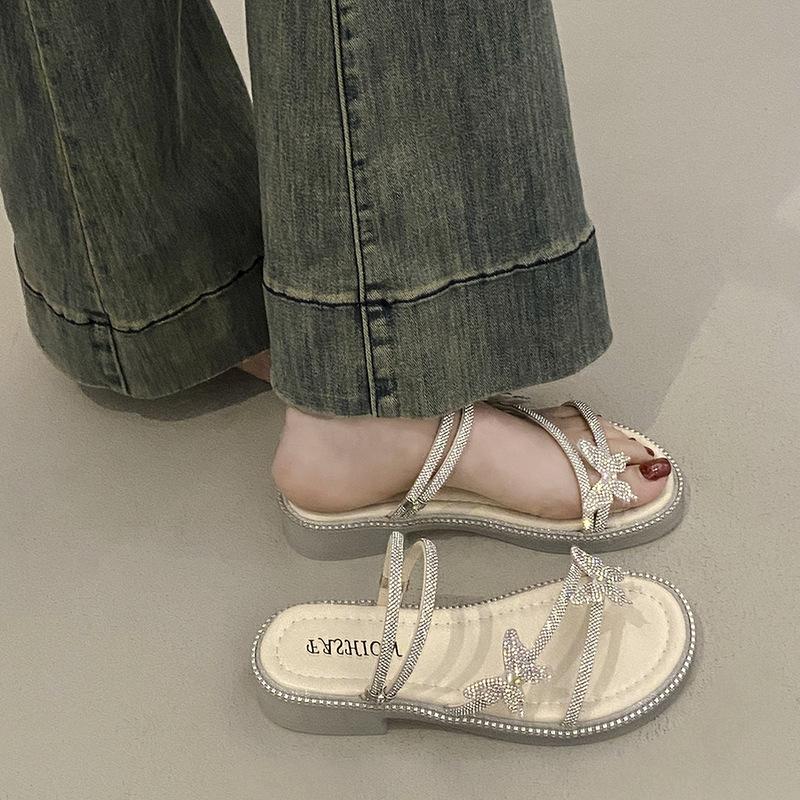 Beautiful slippers female 2025 summer wear new Internet celebrity butterfly rhinestone one-word drag fairy wind beach two sandals