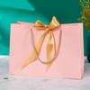 In-Stock White Cardboard Gift Bags with Bow Handle, Customizable Logo for Clothing Stores