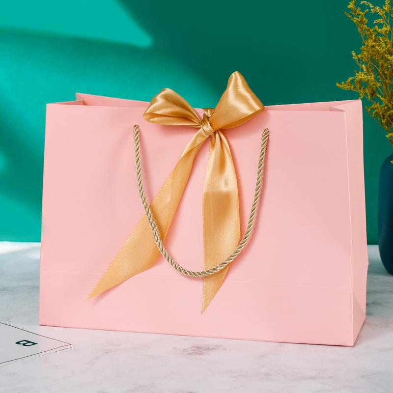 In-Stock White Cardboard Gift Bags with Bow Handle, Customizable Logo for Clothing Stores