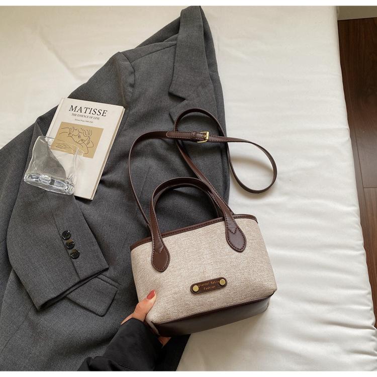 

Canvas splicing portable small bag women 2025 new high-end sense work small bag retro casual messenger bag tide