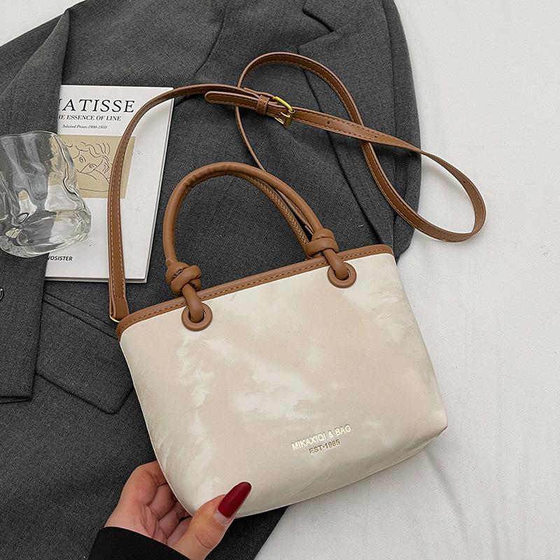 Korean version ins trendy personality contrasting colors casual hand carrying bucket bag fashion high sense versatile temperament messenger bag woman