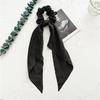 Long flowing ribbon large braided hair accessory for women - ponytail bun hair band with floral design, simple and elegant.