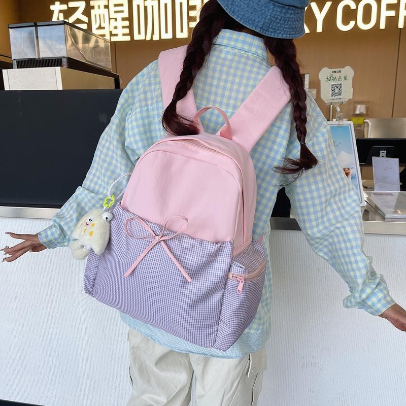 High-value bow ins niche plaid schoolbag for female junior high school students, casual and lightweight college students, travel backpack.
