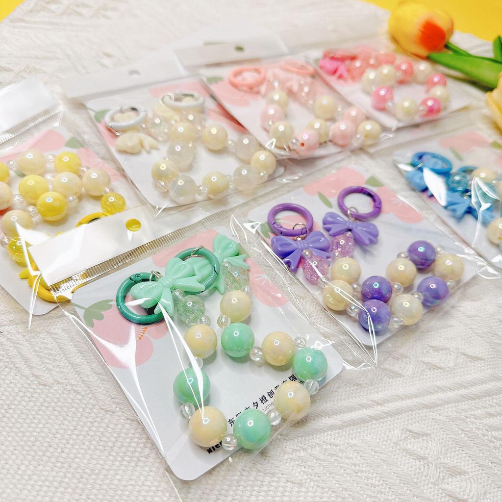 Handmade candy-colored bow bead pendant phone case chain for female students - beaded hand-held jewelry and bag accessory.