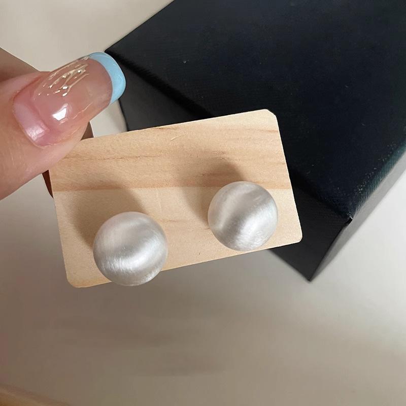 

Минималистичные серьги-пусеты в виде матовых круглых шариков - Нишевый дизайн для осенне-зимней моды.