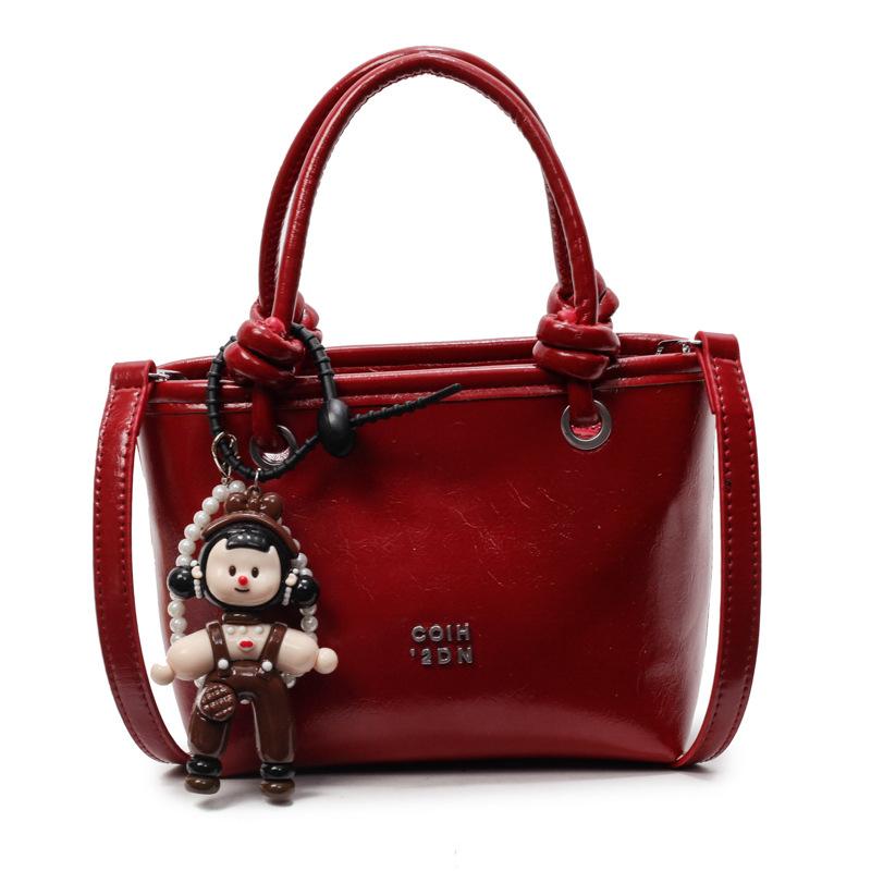 2025 new Korean simple oil wax leather portable bucket bag fashionable versatile solid color foreign style commuter messenger women's bag