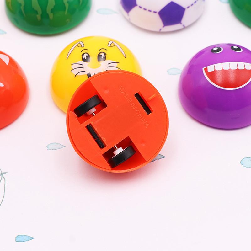 Mini-Aufziehspielzeug aus Kunststoff mit Cartoon-Ausdruck Halbkugel-Design für Kinder und Familienspaß