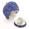 Stylish Scandinavian-style tea cozy with a blue, universe, planet, and garden design. Beige teapot cover. Crafted by artisans Sachiko and Akiko