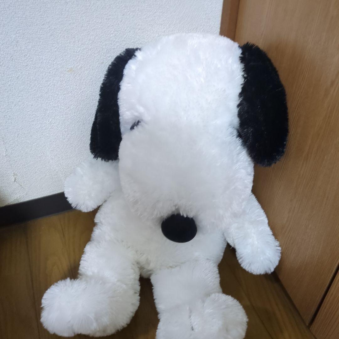 Snoopy stuffed toy with red ribbon