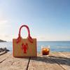 Handwoven Straw Tote Bag with Embroidered Fish Pattern and Wrapped Handles Suitable for Casual Everyday Use and Beach Outings