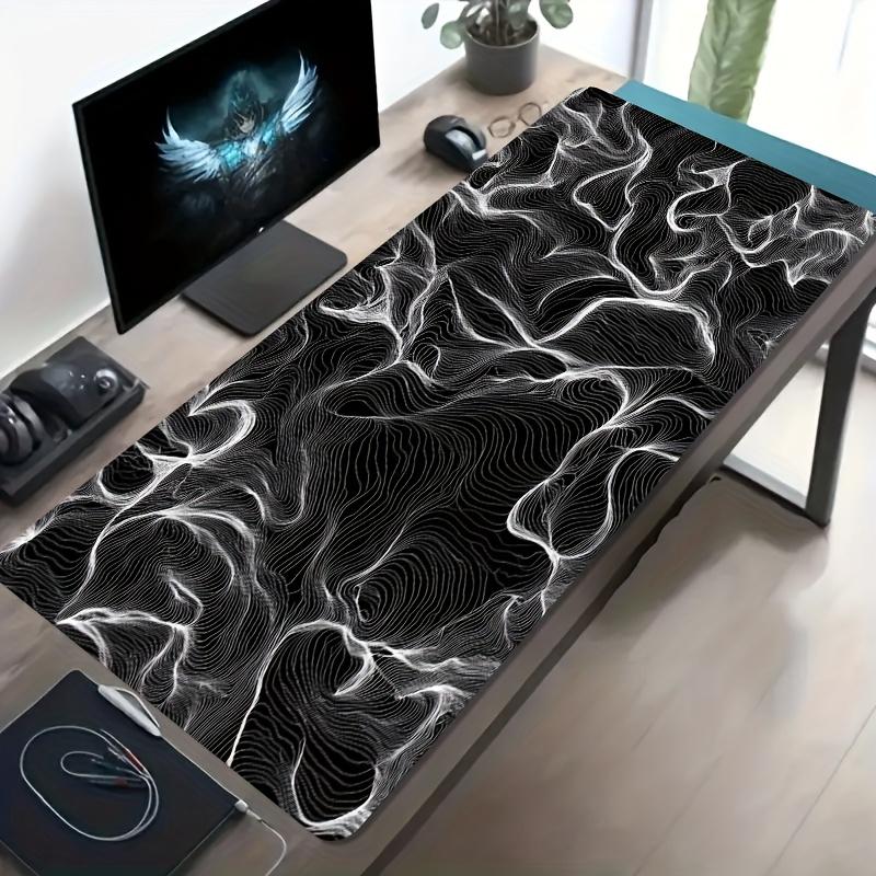 A Large Electronic Sports Gaming Mouse Pad Featuring an Abstract Design with Flowing Black And White Lines