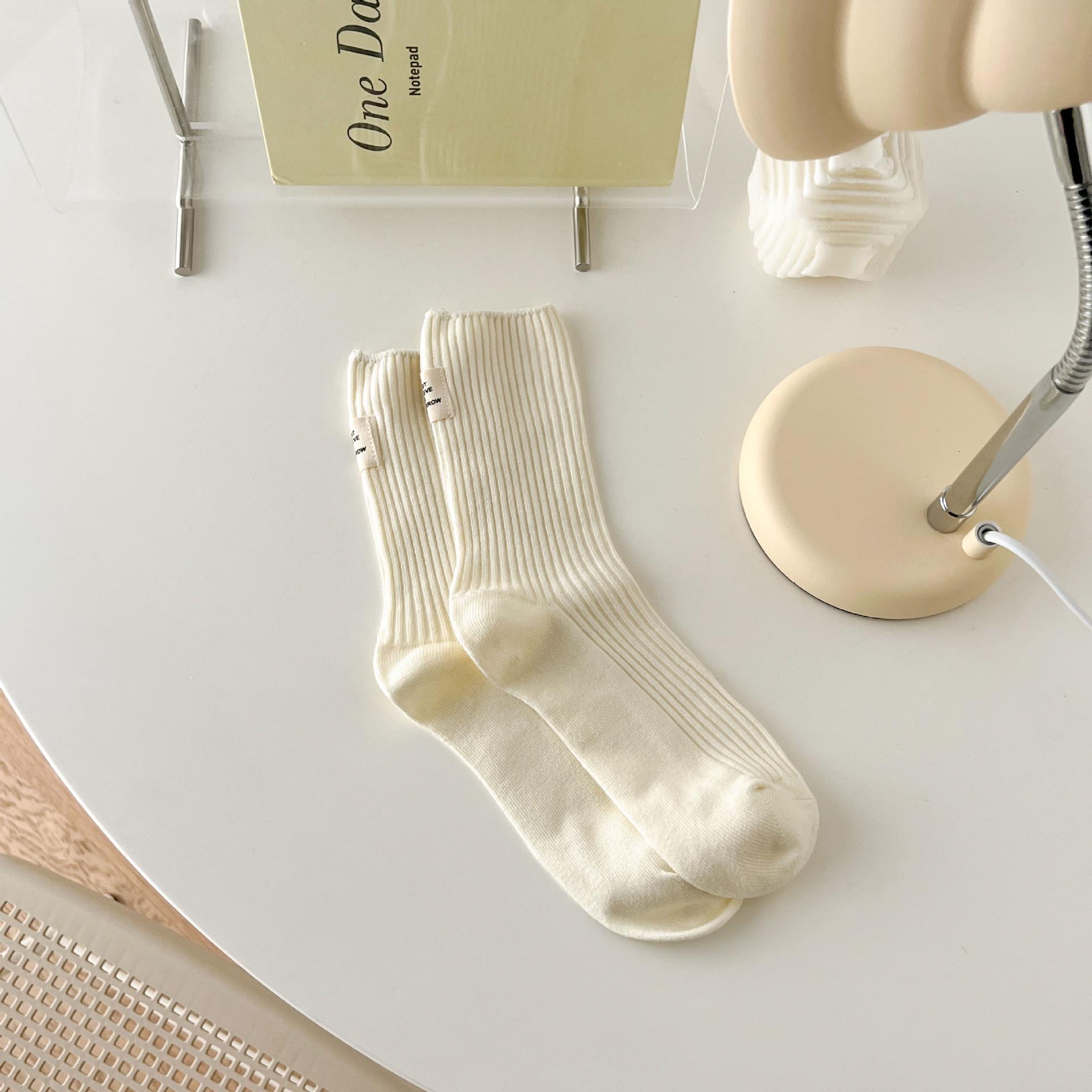 Women s vertical stripe macaron Japanese-style slouch socks with a cream fabric label. One size