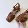 Sheepskin version~ French casual woven hollow bag head sandals women's retro thick heel pig cage shoes vacation style Roman shoes