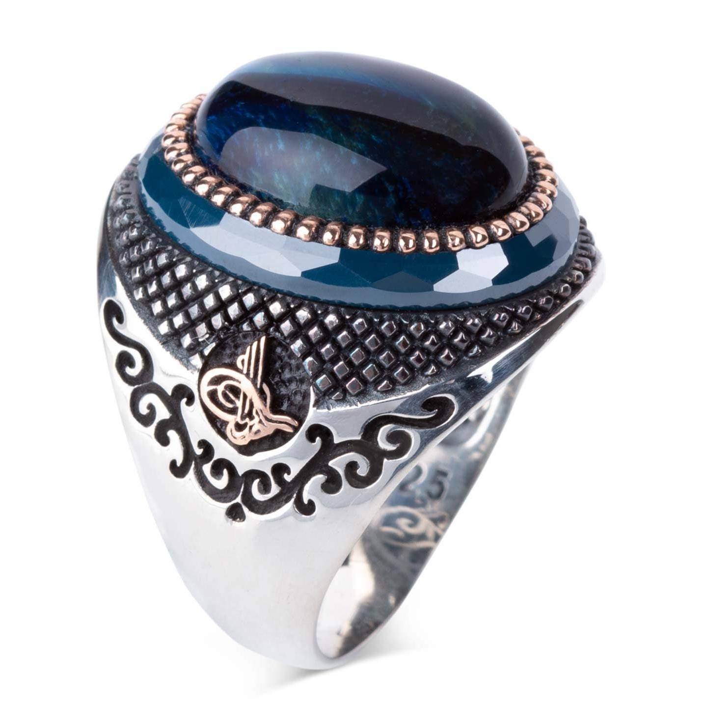 

Серебряное мужское кольцо с голубым тигровым глазом и тугрой по бокам