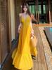 Beautiful yellow v-neck suspender dress for travel and vacation, women's waist and thin swinging seaside dress