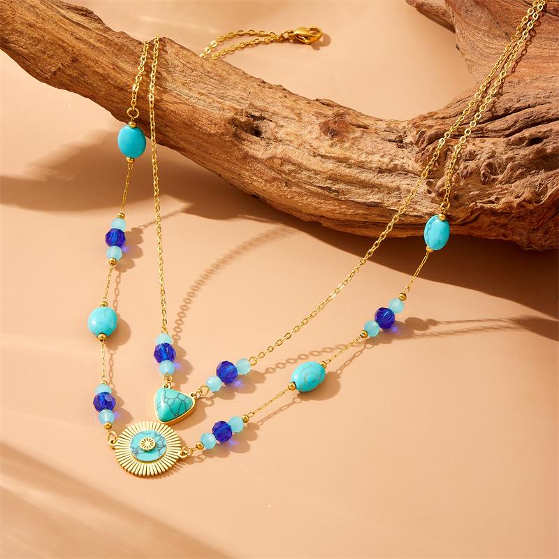 Gold Tone Double Layer Turquoise Beaded Necklace with Sunburst Pendant золотой