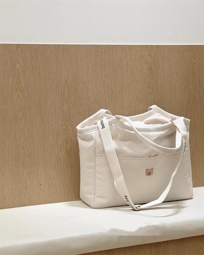 

Korean Multifunctional Canvas Mummy Bag: Lightweight Handheld, Crossbody, and Tote for Moms and Babies