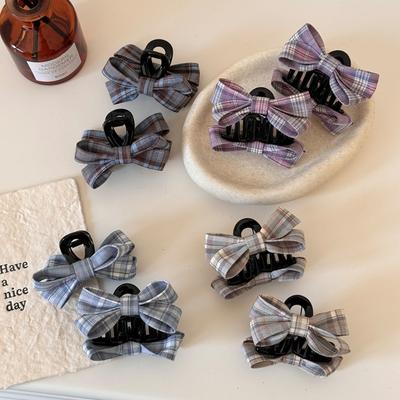 The Princess with The Checkered Bow Accessory Has A Chic Patterned Beak Hairpin At The Back of Her Head and A Hairclip.