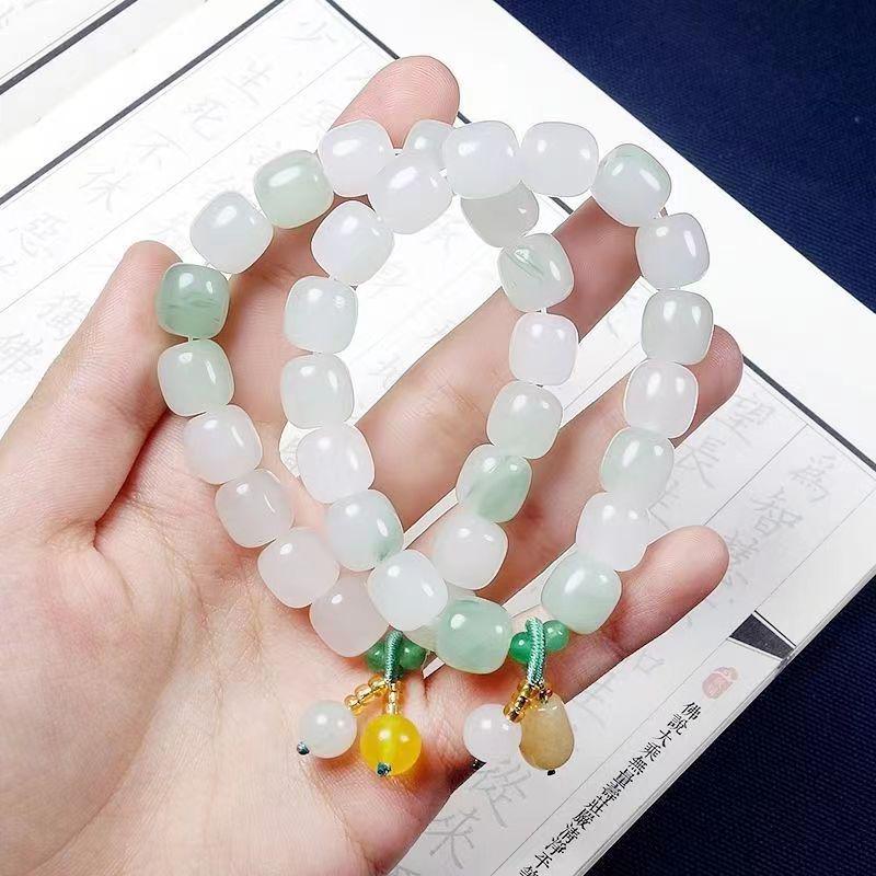 Golden Silk Jade Bracelet: Women's Xinjiang Tianshan Green Jade with Floating Flower Design and Barrel Beads.