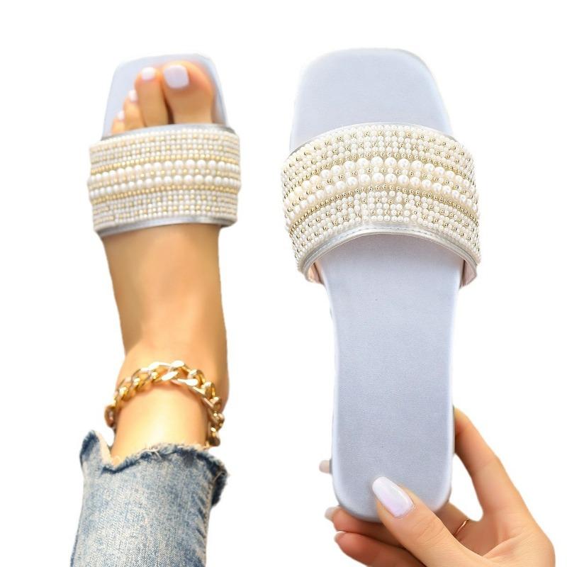 A Woman Wearing Square-toed Straight-line Rhinestone Flat Shoes and A Pair of Home Slippers