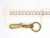 Heavy-duty fishing hook keychain with swivel and double ring, made of brass.