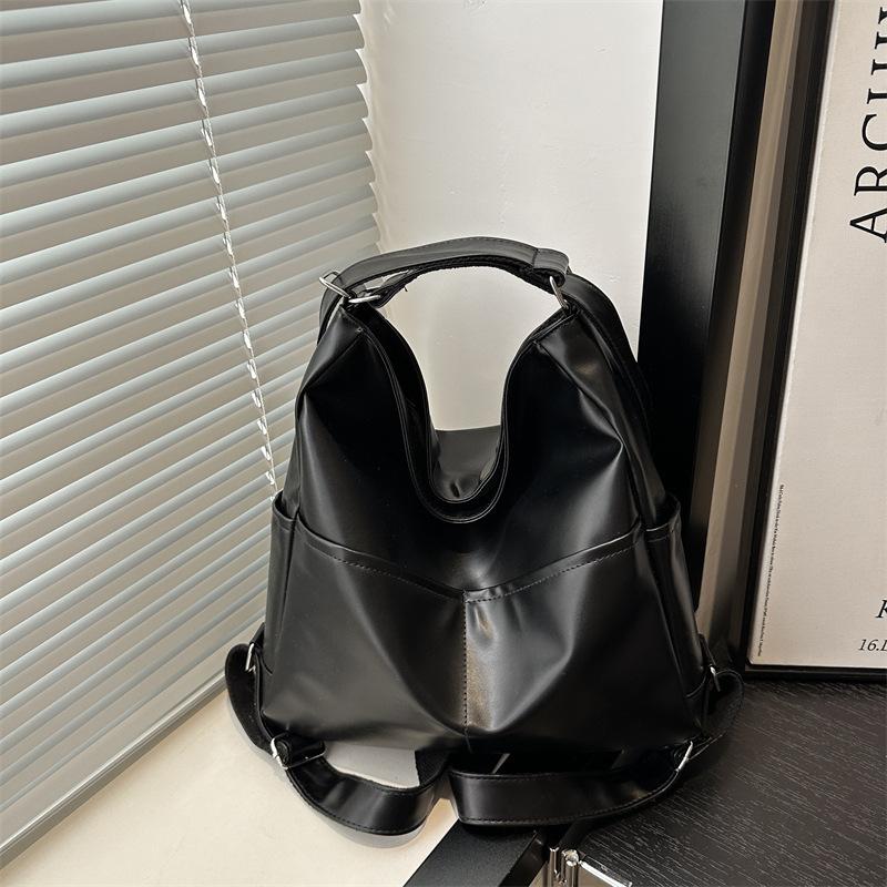

Niche autumn soft leather bag women s commuter tote bag multi-functional backpack oblique span schoolbag large capacity three-purpose backpack чорний