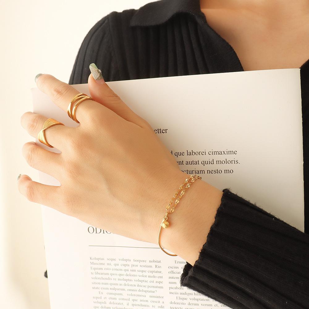 Delicate Double Layer Lip Chain Bracelet with Small Bead Pendant, Gold-Plated Titanium Steel.